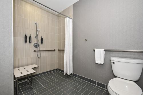 a bathroom with a toilet and a shower at Aloft Charlotte City Center in Charlotte
