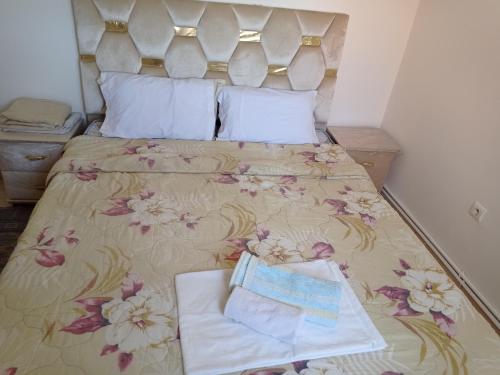 a bed with two towels sitting on top of it at maison Halima in Ifrane