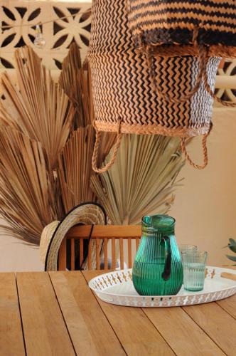 a green vase sitting on a plate on a table at Double Room, attached bathroom - Casa del Indiano in La Orotava