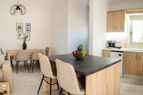 a kitchen and dining room with a table and chairs at Alonakia Home Suites in Filiatra