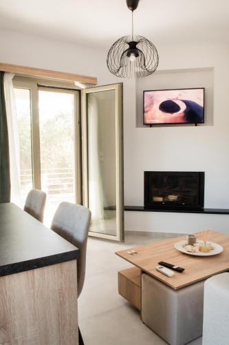 a living room with a table and a fireplace at Alonakia Home Suites in Filiatra