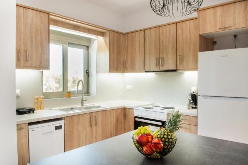 a kitchen with a bowl of fruit on a counter at Alonakia Home Suites in Filiatra