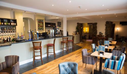 a bar in a restaurant with tables and chairs at Springer Villa, 2 bed, Newquay in Newquay