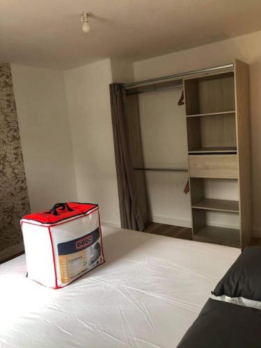 a box sitting on top of a bed in a bedroom at La Perle Marine in Le Vivier-sur-Mer