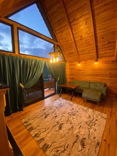 a living room with a large window and a couch at Oksijen suit in Artvin