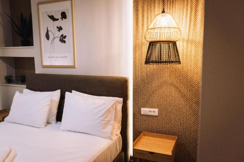 a bedroom with a bed with a lamp next to it at Vallia Suites-Green Luxury Suite A3 in Nafpaktos