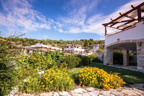 a view of a garden with yellow flowers at Holiday Lodge al Porto in Mattinata