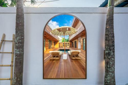 an arched window frames the front porch of a house at ZenDen in Canggu