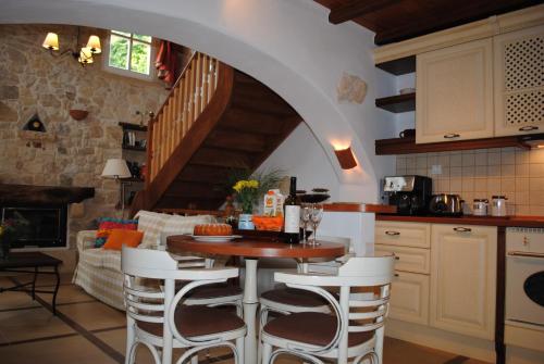 a kitchen with a table and chairs in a room at Rock House's Villa Melody in Plataniás