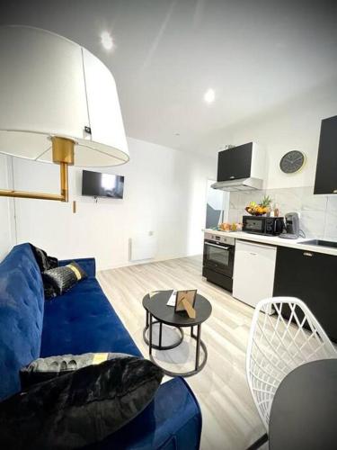 un salon avec un canapé bleu et une table dans l'établissement 【】Le Prestigieux【】 , Belfort ville, à Belfort