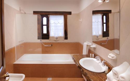 een grote badkamer met een bad en een wastafel bij Aldea de los Pajaros in Villa General Belgrano