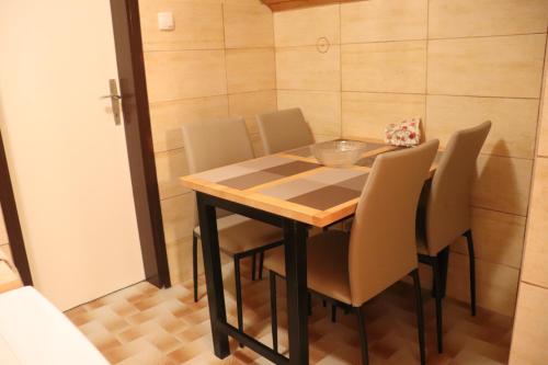 a dining room table and chairs in a room at Saint Nicolas Bajina Bašta in Lug