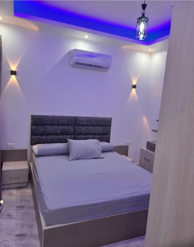 a bedroom with a bed with purple lights on it at SELENA BAY RESORT WITH PRIVATE BEACH,SEA VIEw in Hurghada