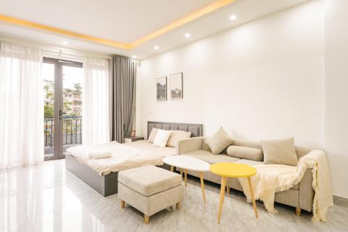 a living room with a couch and a table at A Room Apartment River view in Haiphong Walking Str in Hai Phong