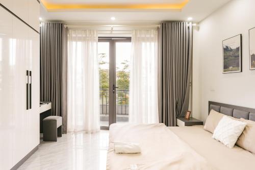 a bedroom with a bed and a large window at A Room Apartment River view in Haiphong Walking Str in Hai Phong