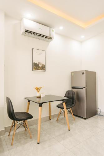 a dining room with a table and a refrigerator at A Room Apartment River view in Haiphong Walking Str in Hai Phong