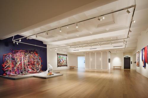 a large room with paintings on the walls at 21c Museum Hotel St Louis in Saint Louis