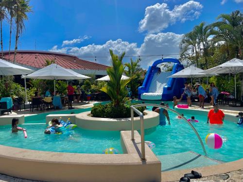 a group of people in the swimming pool at a resort at Summit Rainforest Golf Resort & All Inclusive in Paraíso