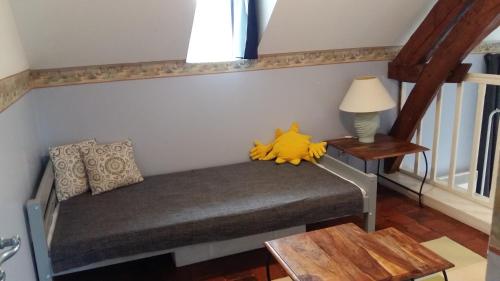 a stuffed animal sitting on a bench in a room at 21 rue de l'Olivet in Orbigny