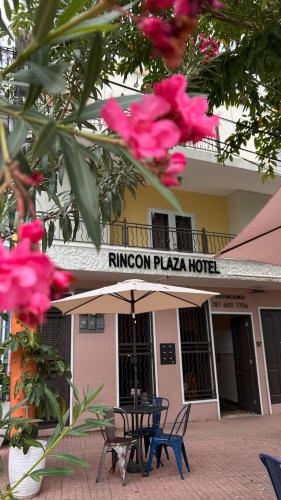 a table and chairs in front of a hotel at Rincon Plaza Hotel in Rincon
