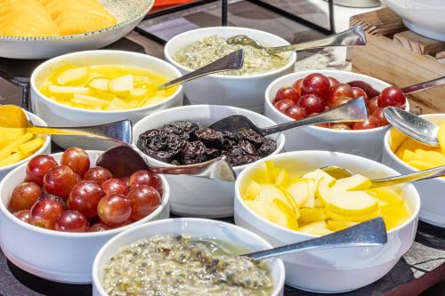 a bunch of bowls of different fruits and vegetables at Sonesta Hotel Bogotá in Bogotá