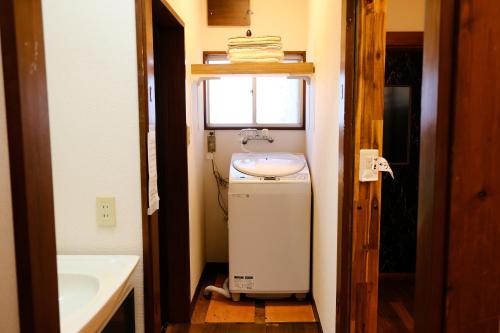 a small bathroom with a sink and a window at Forest-inn Kasama in Kasama