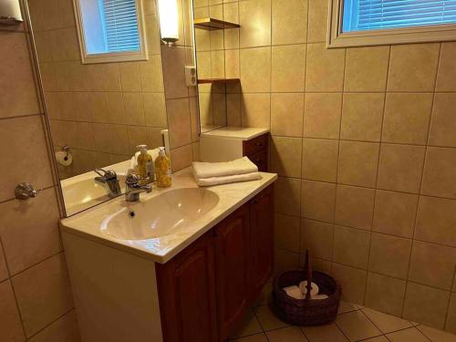 a bathroom with a sink and a mirror at Seaside Comfort with Terrace - Business and Leisure Friendly in Tønsberg