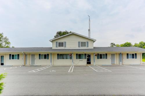a large white building with a parking lot at Stone Fountain Motel in Fenelon Falls