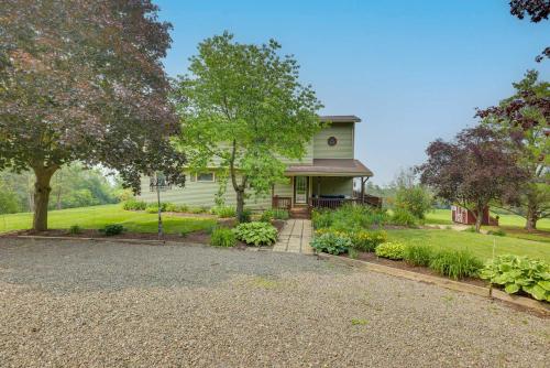 a house with a gravel driveway in front of it at Spacious Hammondsport Home on 6 Acres with Lake View in Hammondsport