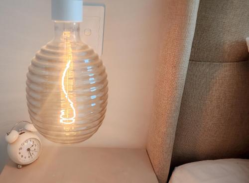 a light bulb sitting on a table next to a clock at Kaneel Suiker in Paarl