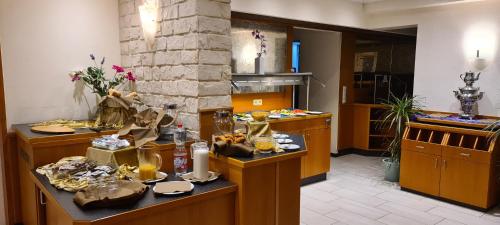 a kitchen with a table with food on it at Hotel Strand-Café in Roßbach