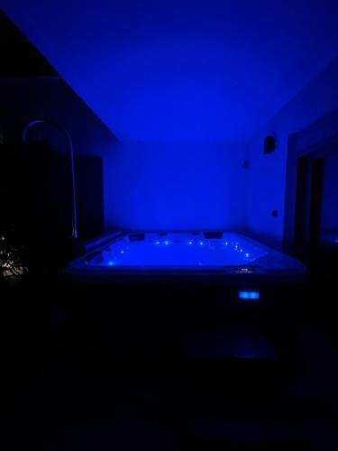 a blue room with a tub with a sink at Sounio - Waterfront Luxury Spa Villa Pounta Zeza 170 sqm on Private Beach in Sounio