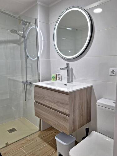 a bathroom with a sink and a shower and a mirror at Casa Bonita Vista - Playa del Inglés in Playa del Ingles