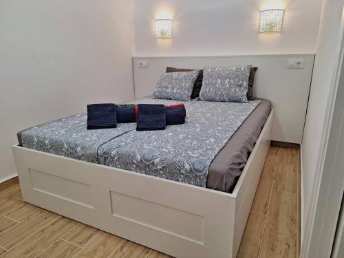 a bed in a bedroom with two pillows on it at Casa Bonita Vista - Playa del Inglés in San Bartolomé de Tirajana