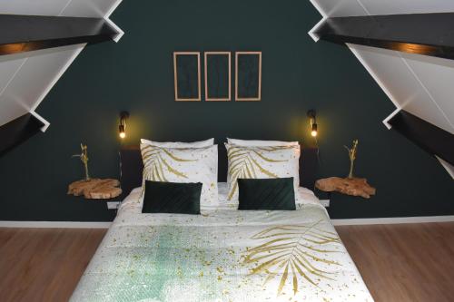 a bedroom with a large bed with black walls at B&B Ouddorps Huisje in Ouddorp