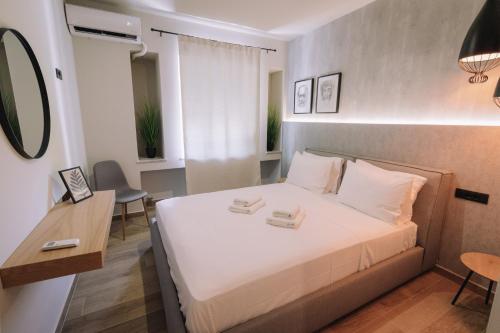 a bedroom with a bed with two towels on it at Vallia Suites-Red Luxury Suite B3 in Nafpaktos