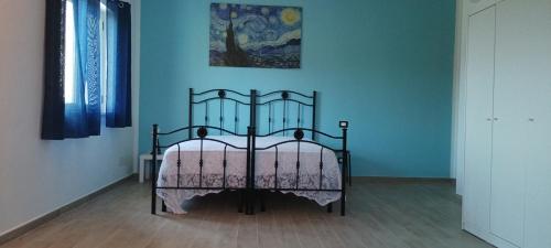 a bed in a room with blue walls at Villa Lancellotti in Agropoli