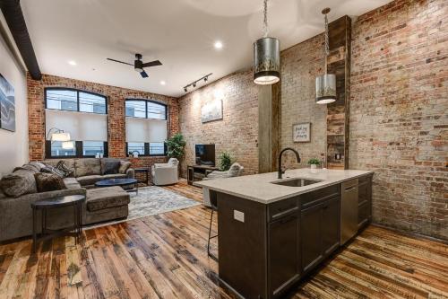 a kitchen and living room with a brick wall at Fabulous Downtown 2 bedroom Condo in Asheville