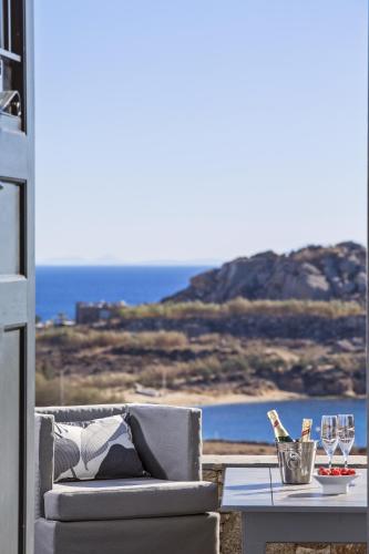 a couch and a table with a view of the ocean at Almyra Guest Houses in Paraga
