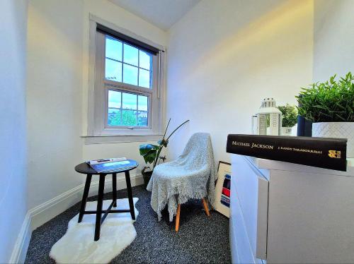 a small room with a table and a chair at Charming room in Central London in London