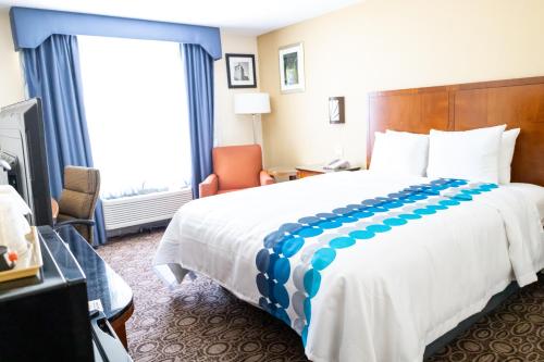 a hotel room with a large bed and a window at Baymont by Wyndham College Park Atlanta Airport South in Atlanta