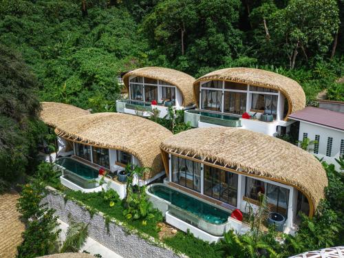 an aerial view of a house with thatched roofs at Three Monkeys Villas in Patong Beach