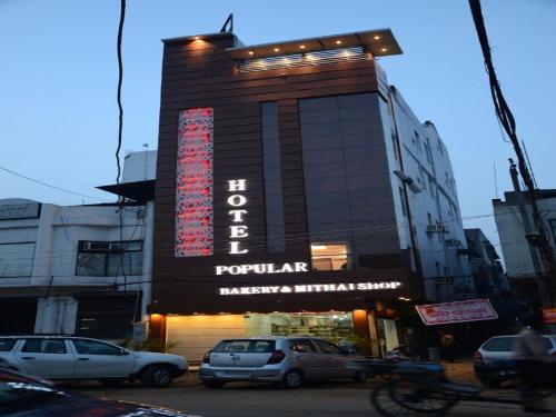 a building with a sign on the front of it at Hotel Popular in Amritsar