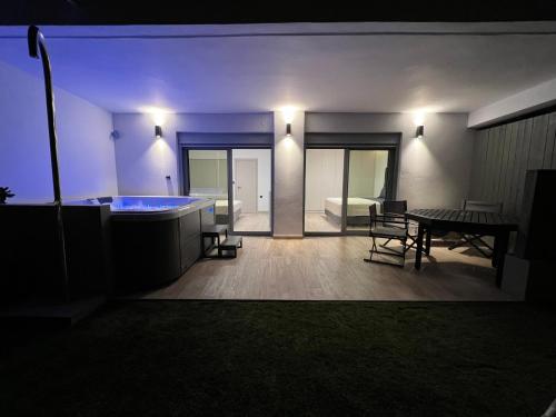 a room with a tub and a table and a dining room at Sounio - Waterfront Luxury Spa Villa Pounta Zeza 170 sqm on Private Beach in Sounio