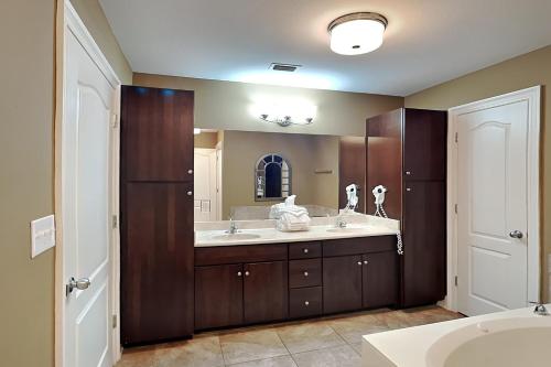 a bathroom with two sinks and a large mirror at Phoenix West II #1407 in Orange Beach