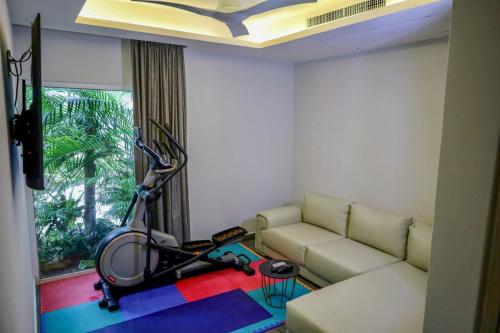 a living room with a couch and a treadmill at Solmare Apartments & Suites in Akumal