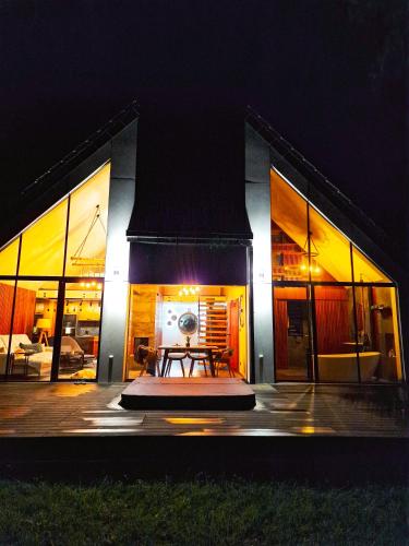 a building with a table in front of it at night at Bobrowa Ostoja in Łukta