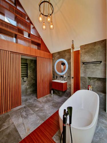 a bathroom with a large tub and a sink at Bobrowa Ostoja in Łukta