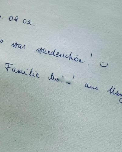 a letter with handwriting on the side of a wall at Schloss Moosburg Gästehaus in Moosburg