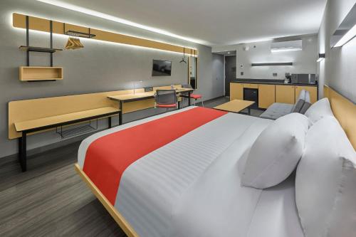 a hotel room with a large bed and a desk at City Express by Marriott Tapachula in Tapachula